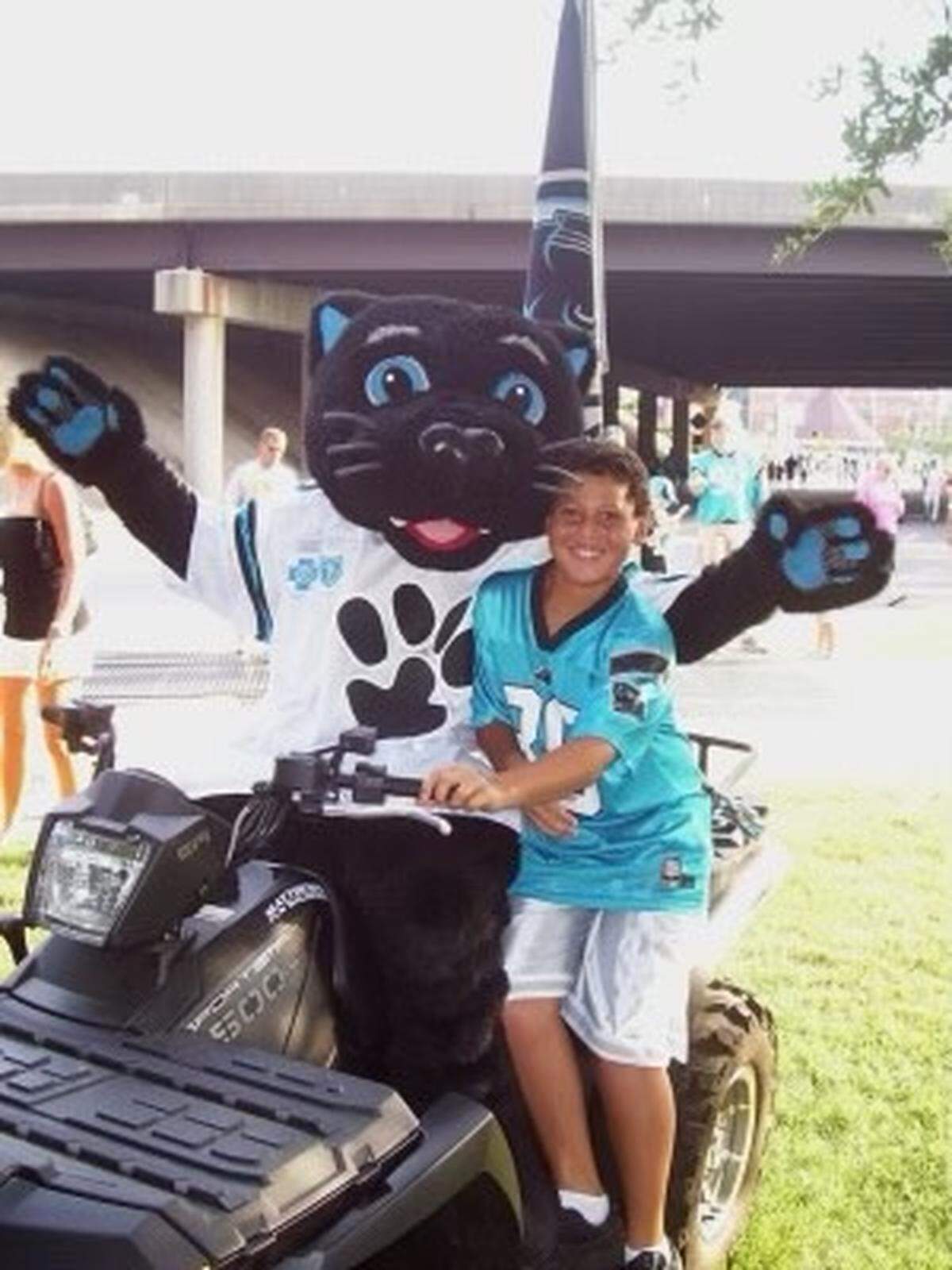 A young Alex Highsmith poses with the Carolina Panthers’ mascot.