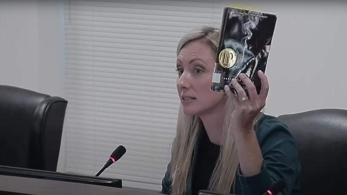 Laura Blackwell, vice chair of the Cabarrus County school board, holds up a copy of John Green’s 2005 “Looking for Alaska” during a Sept. 12, 2022 meeting. Blackwell, who objects to the book being in high school libraries, read aloud a passage from the book that depicted oral sex.