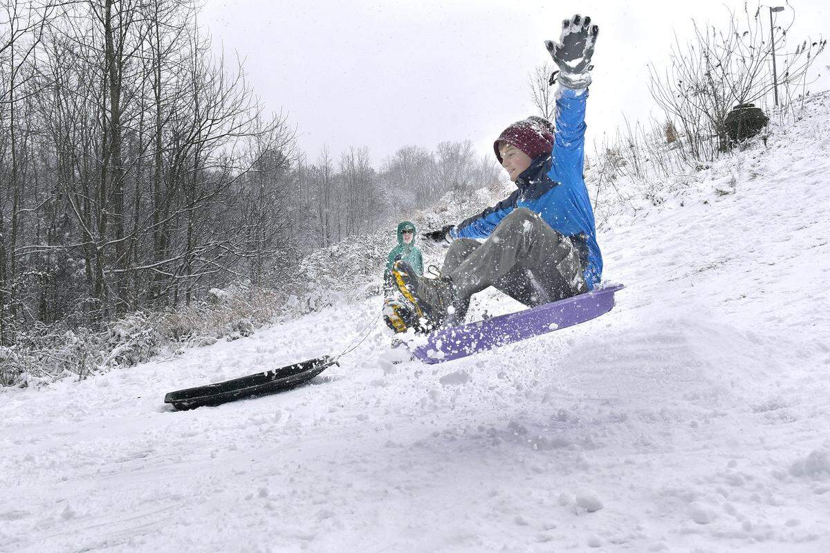 Spencer Stott, 11, spreads his arms like wings as if to fly as he clears a snow ramp behind Mallard Creek Elementary School on Wednesday, Jan. 17, 2018.