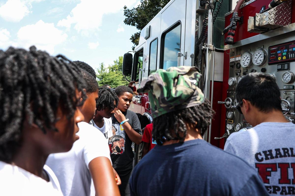 The junior varsity get a tour of a fire truck from Fire Station 36 during Impact Camp at Johnson C. Smith University in Charlotte on Monday, July 21, 2025. Impact Camp offers 300 spots for a week-long free camp based in teaching young boys the importance of education, entrepreneurship, enlistment, employment and that there are many different positive paths in their lives.