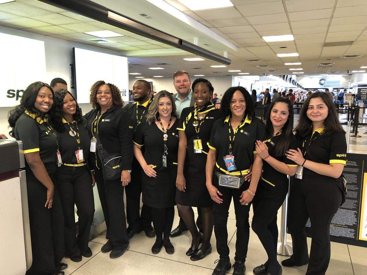 Spirit’s Vice President of Network Planning, John Kirby (center) posed with Spirit employees as they prepared for the airline’s first day of flights at Charlotte Douglas International Airport.