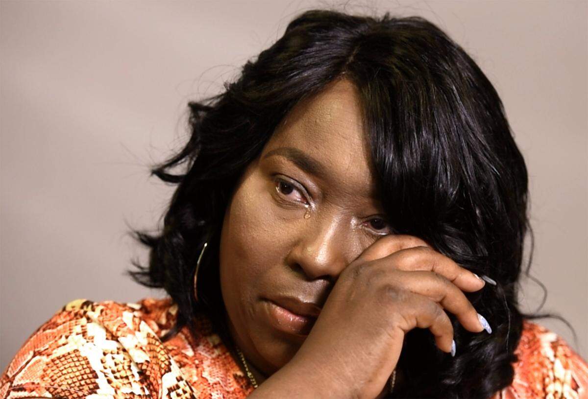 Chantale Tshiona wipes away tears as she talks about the murder of her son, Kynyatta.