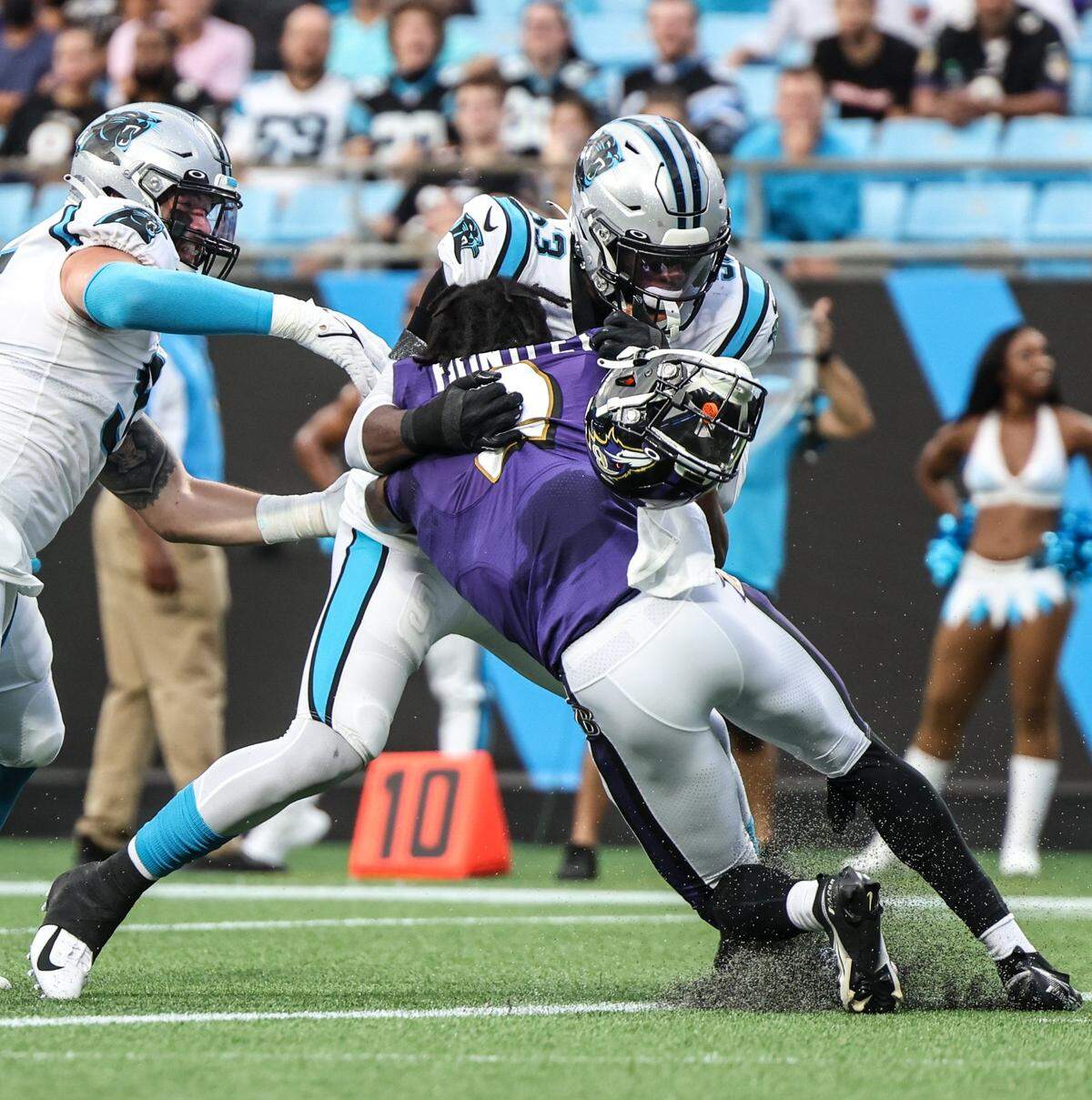 Panthers defensive end Brian Burns knocks the helmet off Ravens QB Tyler Huntley.