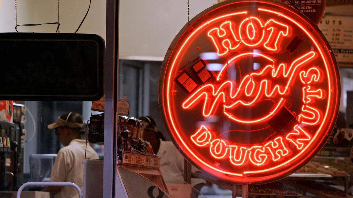 A seasonal favorite will return to Krispy Kreme alongside a collection of new holiday doughnuts. (AP Photo/Chuck Burton)