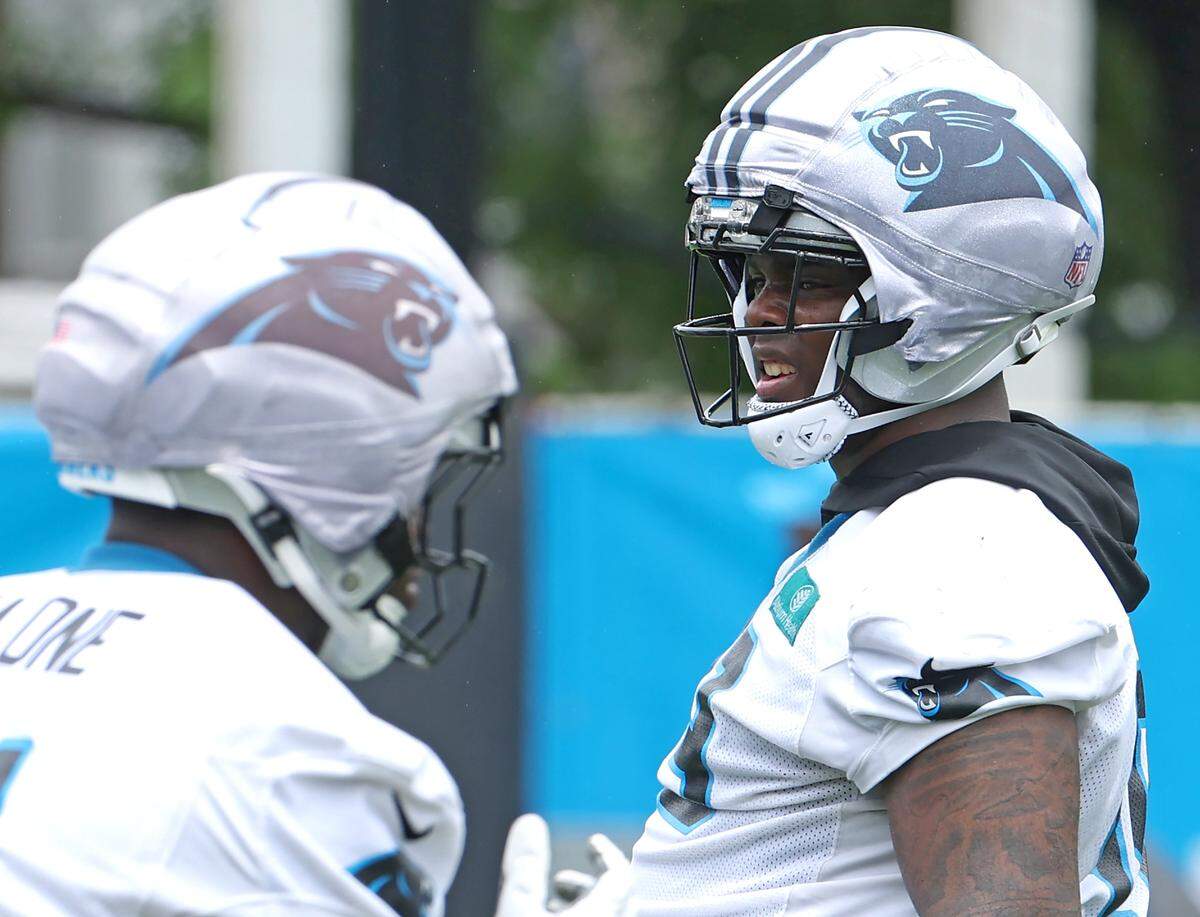 Carolina Panthers defensive tackle Cam Jackson, right, watches his teammates run through a drill during the team's first open workout on Tuesday, May 26, 2026.