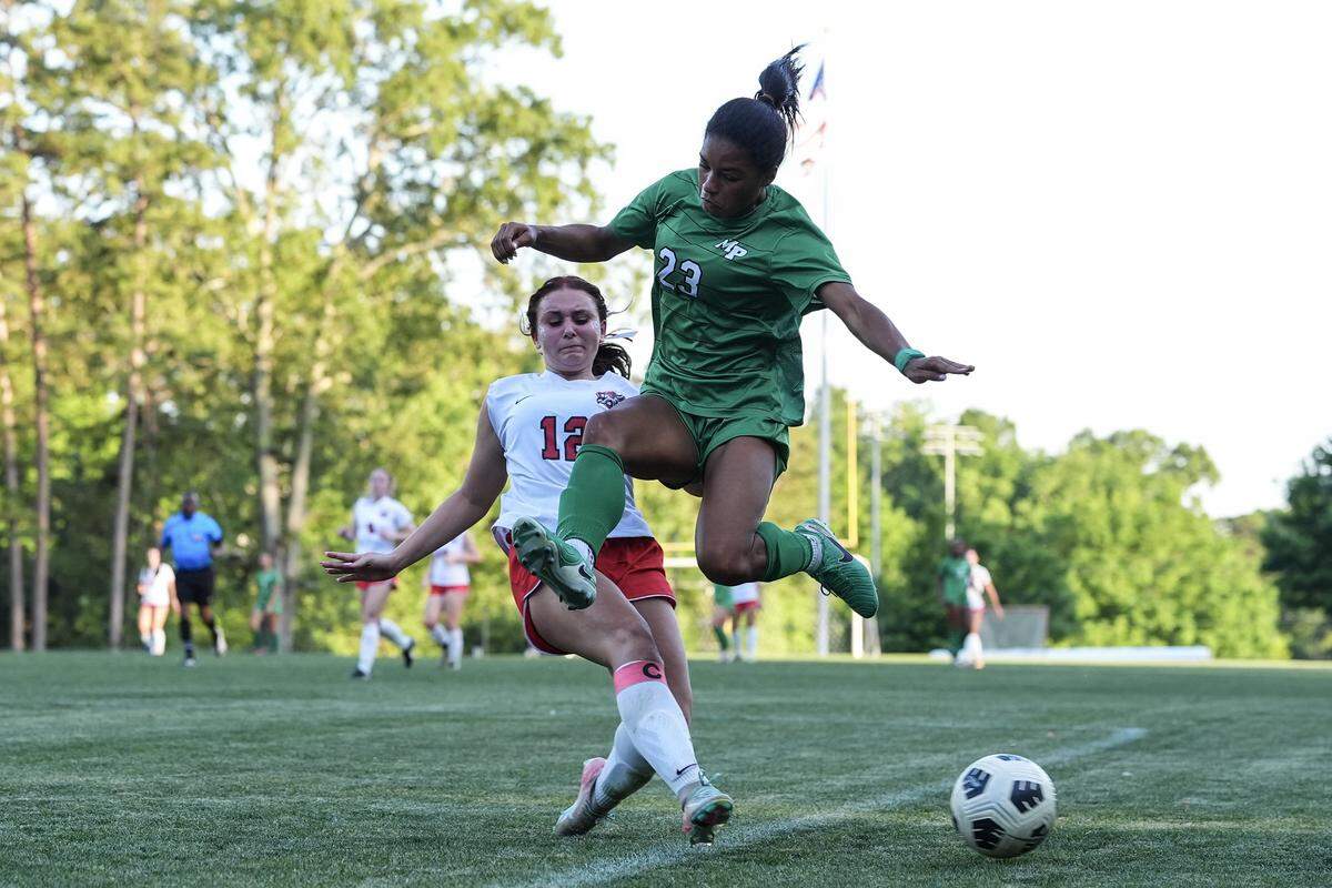 Myers Park’s Amaya Falzarano (23) competes with Northwest Guilford’s Kaylin Hodges (12) for the ball during the second half of a NCHSAA girls playoff soccer match, Monday, May 18, 2026, in Charlotte, N.C. 