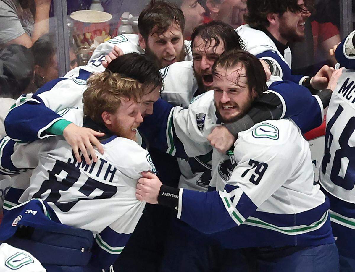 Members of the Abbotsford Canucks celebrate their victory over the Charlotte Checkers in Monday’s Game 6 of the Calder Cup finals at Bojangles Coliseum.