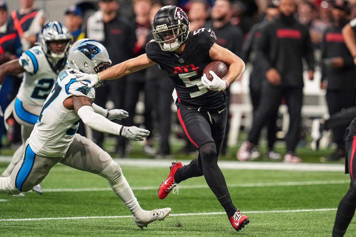 Jan 5, 2025; Atlanta, Georgia, USA; Atlanta Falcons wide receiver Drake London (5) runs against Carolina Panthers linebacker Chandler Wooten (57) after a catch during the first half at Mercedes-Benz Stadium. Mandatory Credit: Dale Zanine-Imagn Images