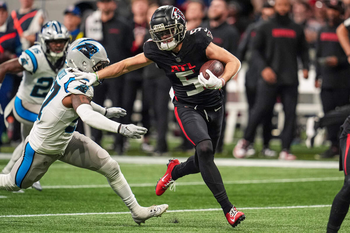 Jan 5, 2025; Atlanta, Georgia, USA; Atlanta Falcons wide receiver Drake London (5) runs against Carolina Panthers linebacker Chandler Wooten (57) after a catch during the first half at Mercedes-Benz Stadium. Mandatory Credit: Dale Zanine-Imagn Images