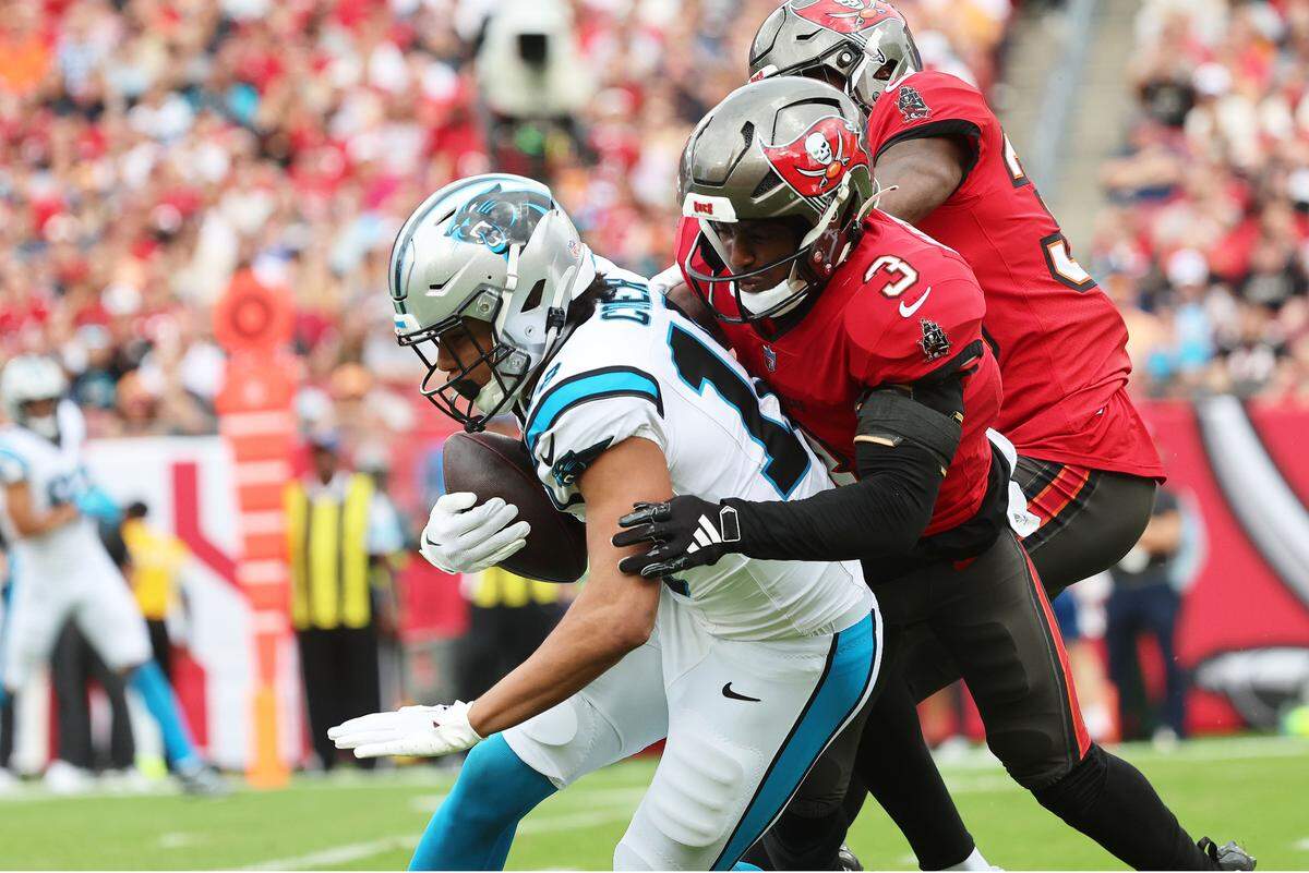 Carolina Panthers wide receiver Jalen Coker (18) runs with the ball as Tampa Bay Buccaneers safety Jordan Whitehead (3) defends during the first quarter at Raymond James Stadium in Tampa, Fl. on Sunday Dec 29, 2024