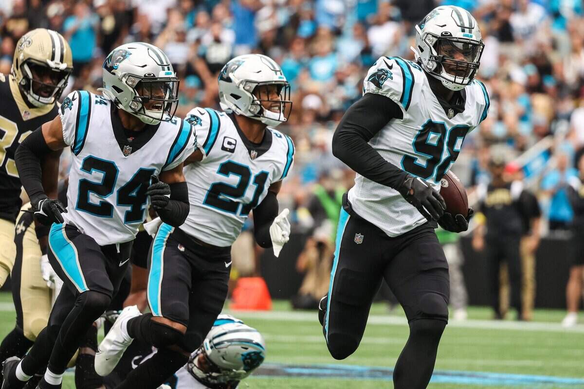 Carolina Panthers defensive end Marquis Haynes, right, runs toward the end zone after recovering a fumble and returning it 44 yards for a touchdown against the New Orleans Saints at Bank of America Stadium on Sunday, September 25, 2022 in Charlotte, NC.
