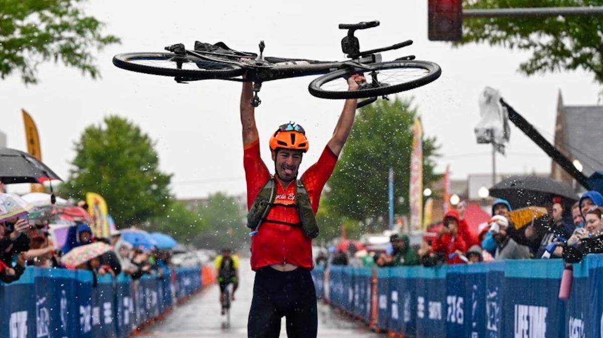 William Harrison of Charlotte said he used his last ounce of energy to raise his Trek Checkpoint gravel bike for a photograph after winning the 350-mile Unbound Gravel XL race in Emporia, Kansas, one of the most prestigious gravel cycling events in the world.