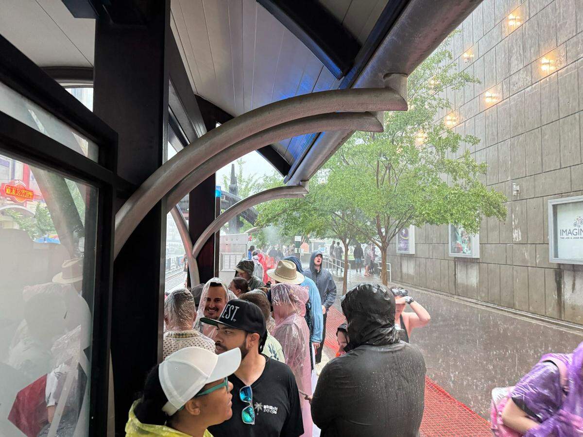 Lovin’ Live Music Festival concertgoers seek cover at the light rail shelters next to The Market at 7th Street amid heavy rainfall on Saturday, May 3 in uptown Charlotte.