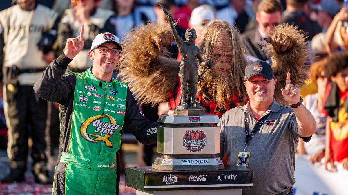 Apr 26, 2025; Talladega, Alabama, USA; NASCAR Cup Series driver Austin Cindric (2) poses with his trophy in Victory Lane at Talladega Superspeedway.