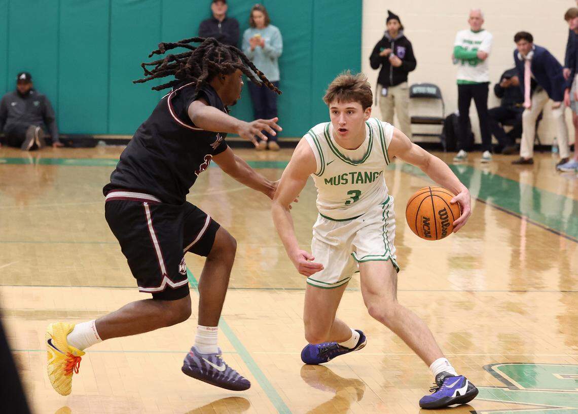 West Meck defender Josiah Bridges, left, applies defensive pressure on Myers Park’s Thomas Vickery, right, during action on Friday, Feb. 6, 2026, at Myers Park High School in Charlotte. West Meck defeated Myers Park 62-59.