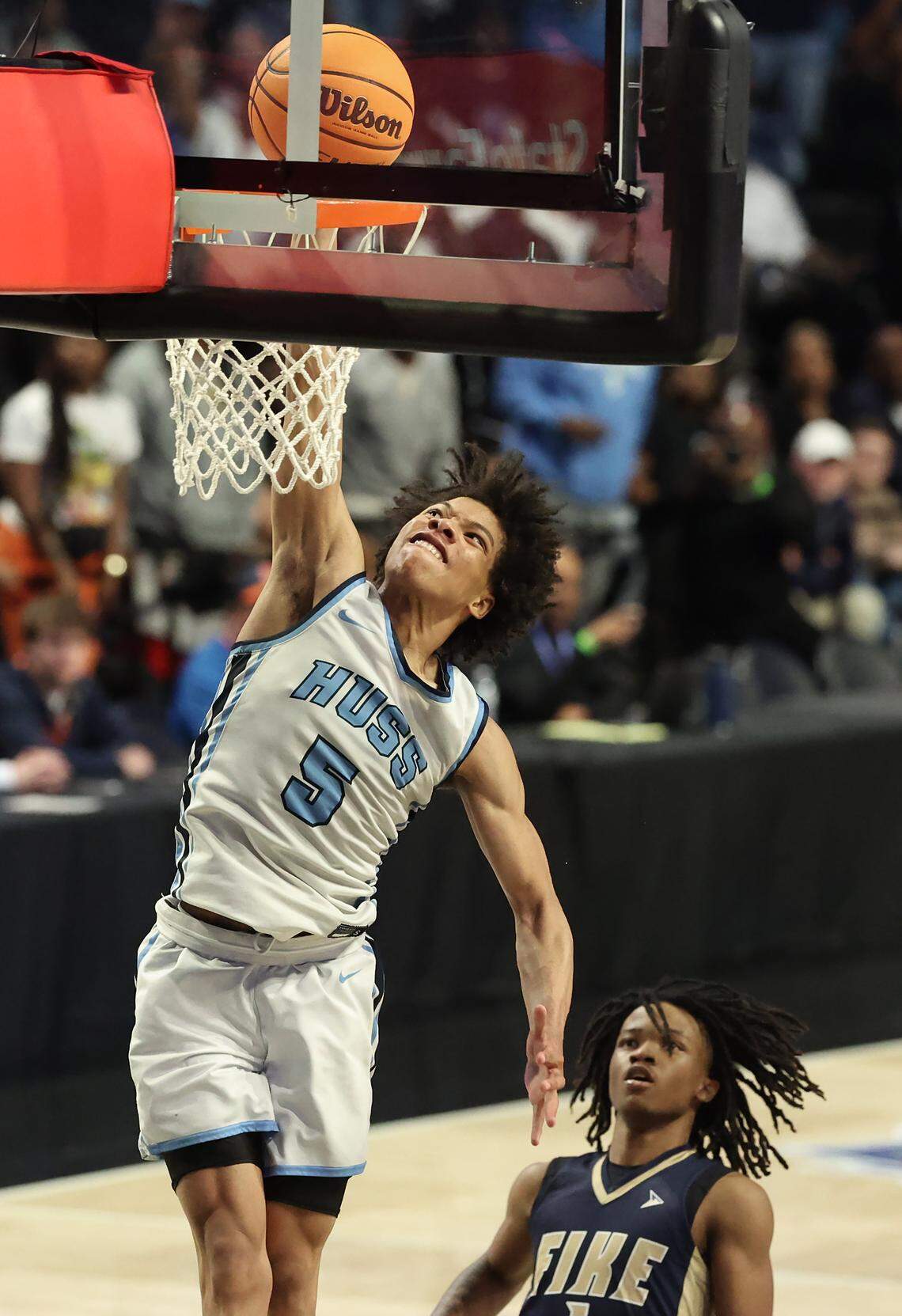 Hunter Huss’s Jaleel Smith, left, throws down a dunk as the Fike defense looks on during the NCHSAA 5A boys championship game on Saturday, March 14, 2026 at Lawrence Joel Veterans Memorial Coliseum in Winston-Salem, NC. Hunter Huss defeated Fike 103-69.
