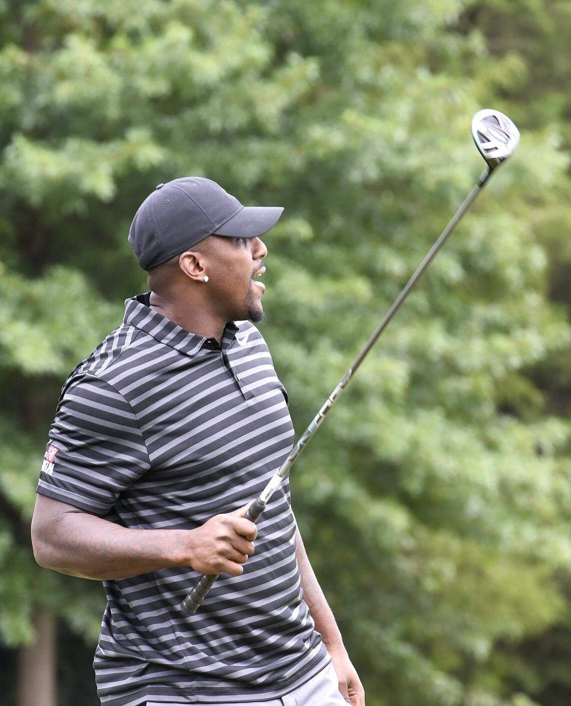 Thomas Davis watches the flight of his drive off the practice tee prior to the Hooptee Celebrity Golf Classic Thursday.The 16th edition of the HoopTee Celebrity Golf Classic at Ballantyne Hotel & Lodge brought athletes, celebrities and others to raise money for a week long basketball camp. They hit the links Thursday, July 19, 2018.