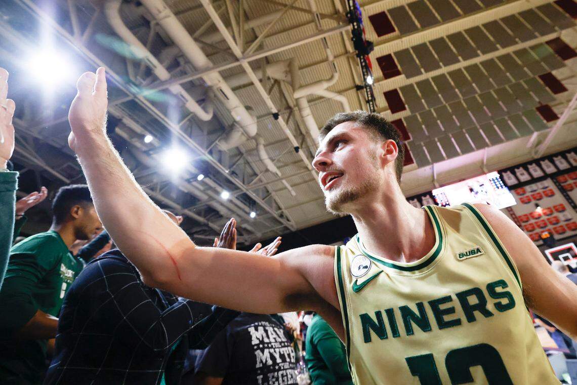Charlotte 49ers guard Nik Graves (10) celebrates with fans after hitting the game winning back over the Davidson Wildcats during a game at Belk Arena in Davidson, N.C., Tuesday, Nov. 29, 2022.