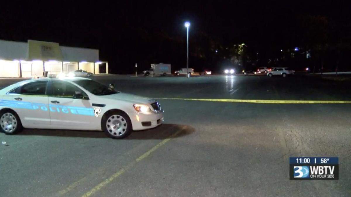 Police investigate after a body was found near the Shoe Warehouse in the strip mall on Freedom Drive. 