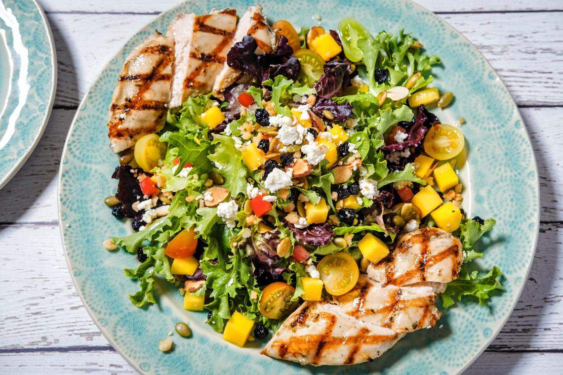The Grilled Chicken & Mango Salad at Tommy Bahama Marlin Bar is gluten-free, with baby greens, toasted almonds, macadamia nuts, feta, pepitas, dried blueberries, vine-ripe tomatoes and a lemon basil vinaigrette.