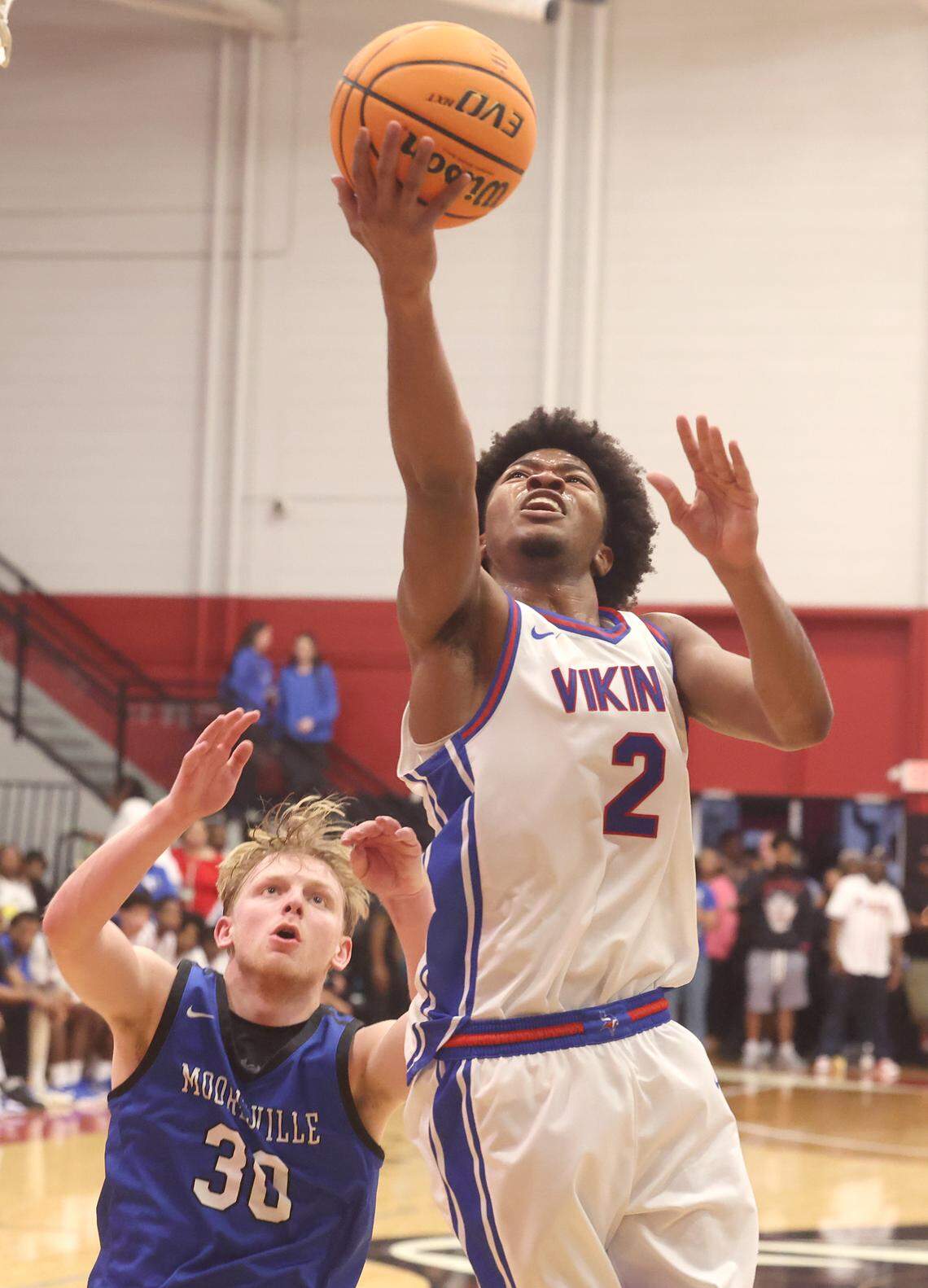 North Meck’s Wilson Estwick, right, drives to the basket for two-points as Mooresville’s Carson Schaen, left, looks on during the boy’s 7A NCHSAA regional championship game at Lenoir-Rhyne University in Hickory, NC on Friday, March 6, 2026.