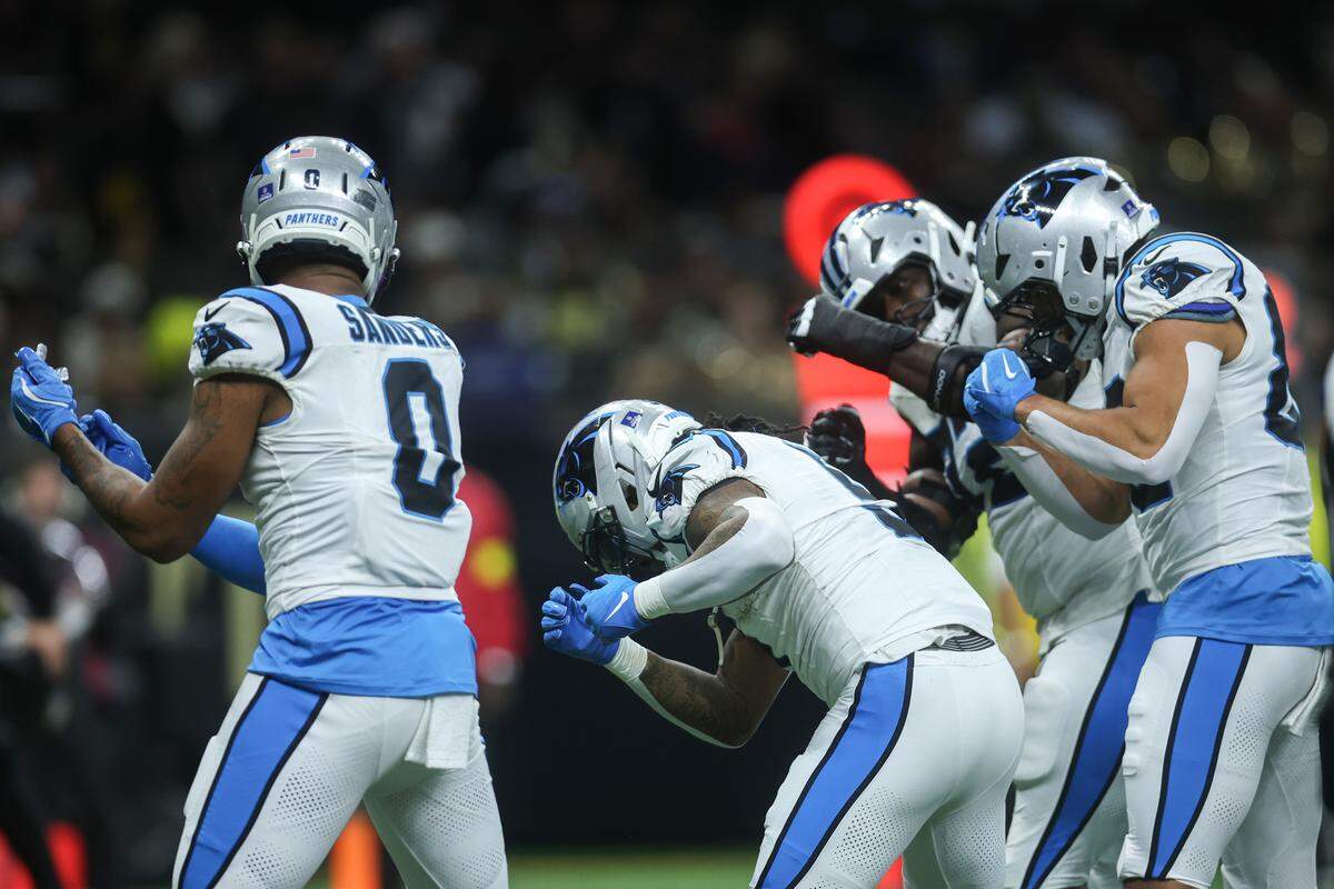 Rico Dowdle (5) of the Carolina Panthers celebrates with teammates after scoring a touchdown during Sunday’s first quarter against the New Orleans Saints at Caesars Superdome.