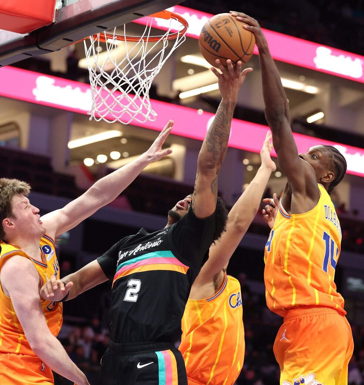 Charlotte Hornets forward/center Moussa Diabate, right, blocks a shot by San Antonio Spurs guard Dylan Harper, center, during action at Spectrum Center in Charlotte, NC on Saturday, January 31, 2026. The Hornets defeated the Spurs 111-106.