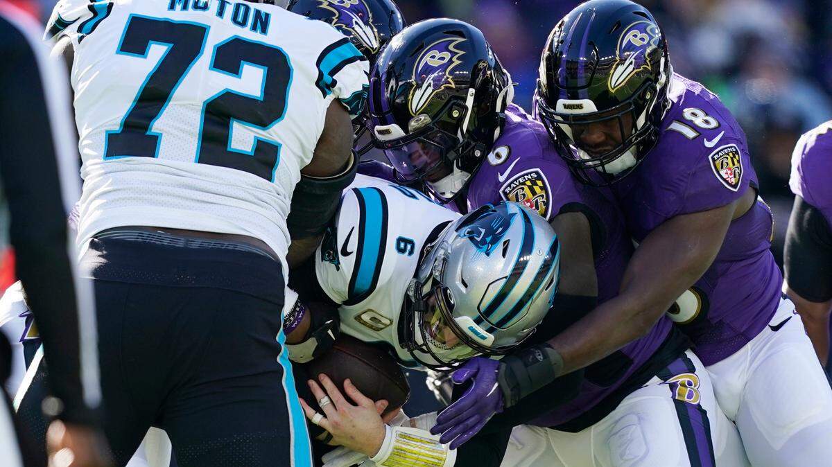 Carolina Panthers quarterback Baker Mayfield (6) is sacked by Baltimore Ravens linebacker Patrick Queen (6) and linebacker Roquan Smith (18) in the first half of an NFL football game against the Baltimore Ravens Sunday, Nov. 20, 2022, in Baltimore. (AP Photo/Patrick Semansky)