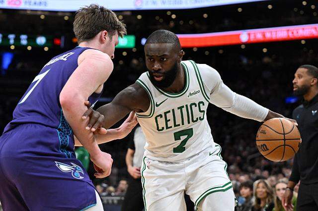 Jaylen Brown of the Boston Celtics drives to the basket against Kon Knueppel of the Charlotte Hornets during the first half at the TD Garden.
