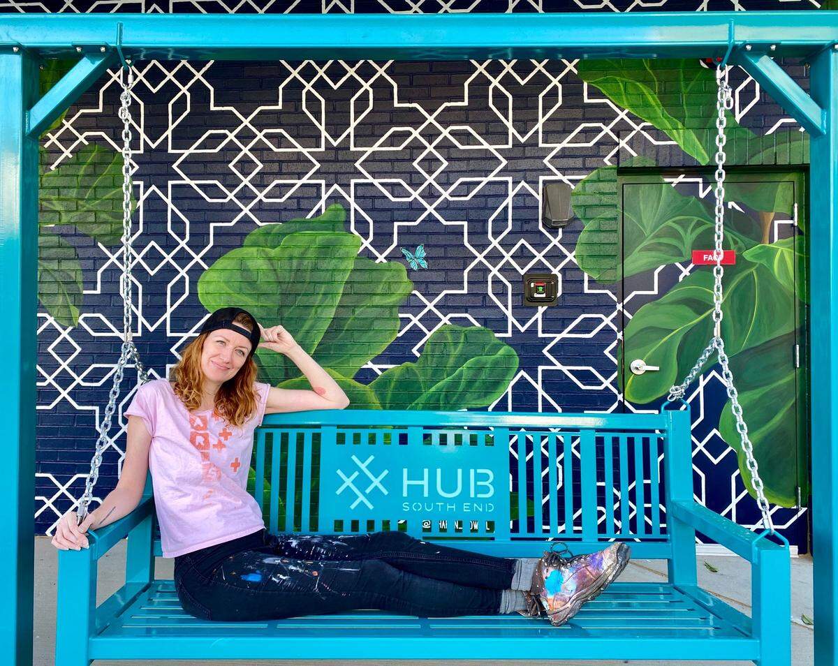 Intertwined artist Sharon Dowell takes a breather on the Hub porch swing.