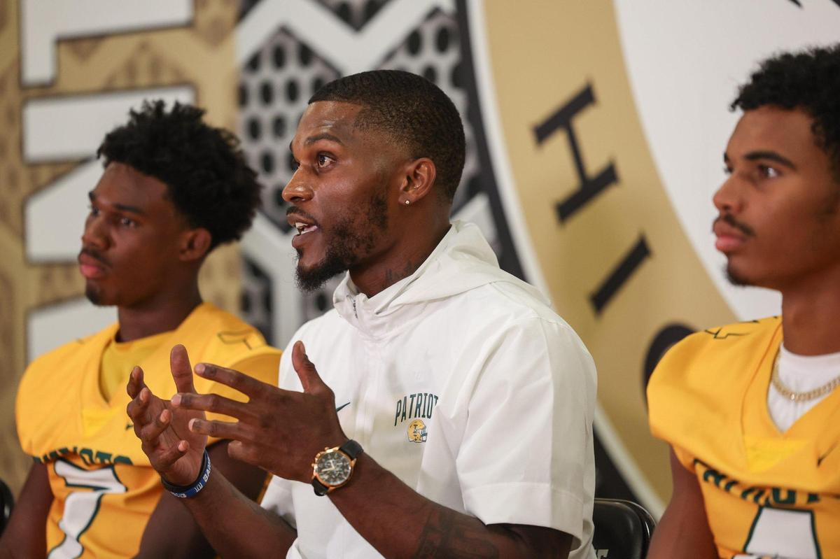 Independence High head football coach DJ McFadden, center, speaks during Southwestern 4A media day at Providence High School on Thursday, July 27, 2023 in Charlotte, NC.