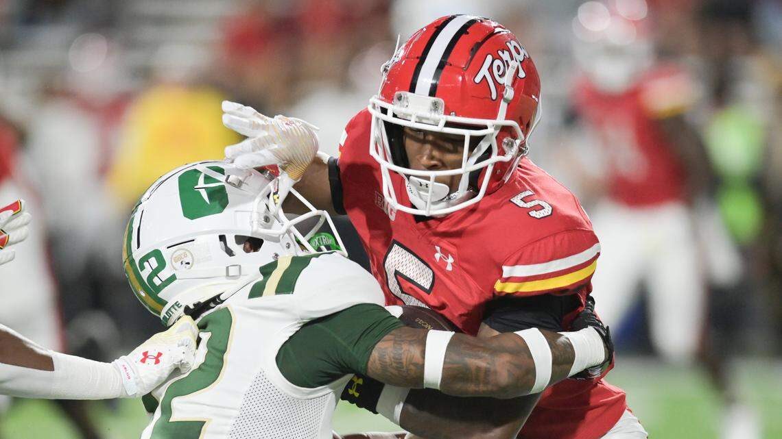 Charlotte 49ers defensive back Dontez Fagan (12) tackles Maryland Terrapins wide receiver Octavian Smith Jr. (5) during the first half at SECU Stadium. / Tommy Gilligan-USA TODAY Sports