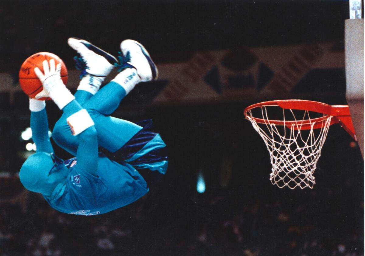 Michael Zerrillo performs The Flip Dunk as Super Hugo during the slam dunk contest at the 1991 NBA All Star Game at the Charlotte Coliseum in Charlotte, NC. Zerrillo performed a Hugo the Hornet for 17 years. Zerrillo was the 3-time NBA Mascot dunk champion