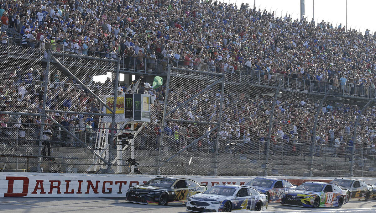 Kevin Harvick (4) leads the field past the green flag at the start of a NASCAR Monster Cup auto race at Darlington Raceway, Sunday, Sept. 3, 2017, in Darlington, S.C. (AP Photo/Terry Renna)