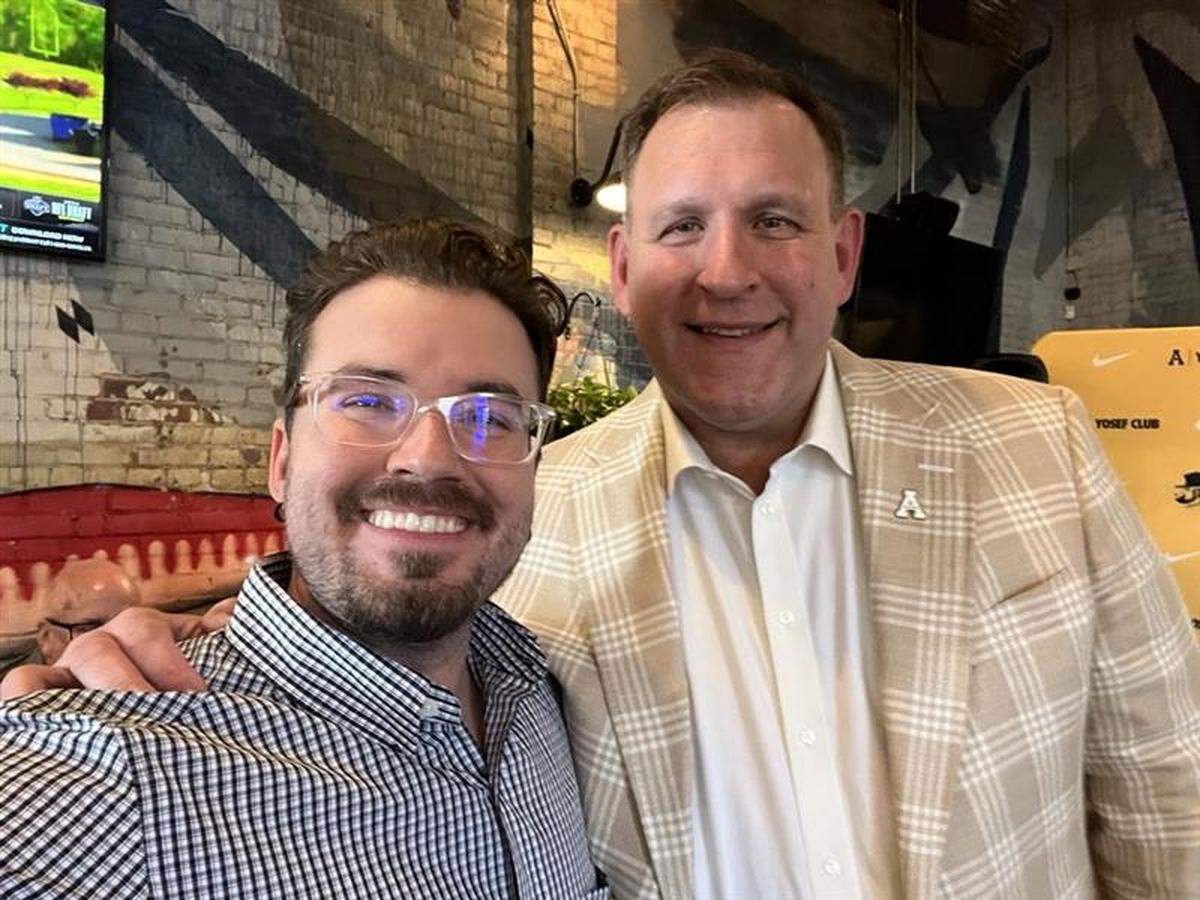 Journalist Ethan Joyce, left, with former Appalachian State football coach Shawn Clark.