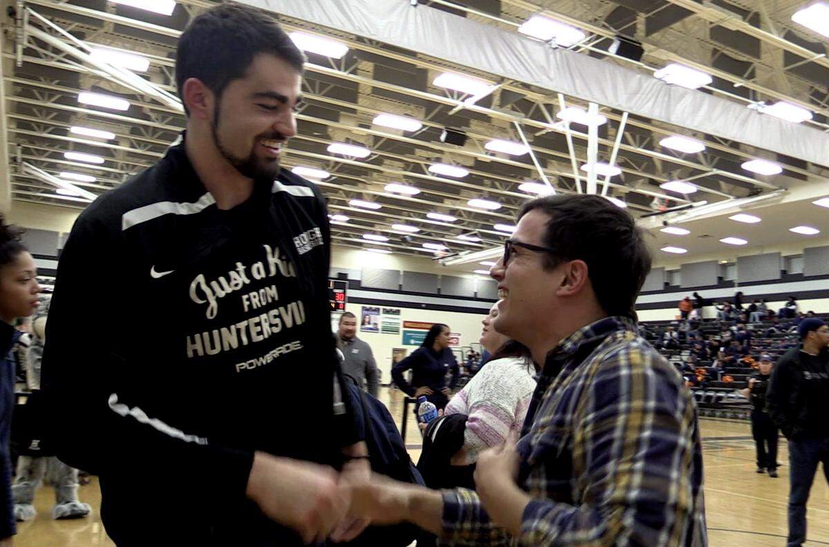 Former Hough Huskies basketball player Luke Maye left, greets an old friend after his jersey was retired prior to the team’s game against the Vance Cougars on Tuesday, January 22, 2019. Maye is now an All-American at the University of North Carolina.