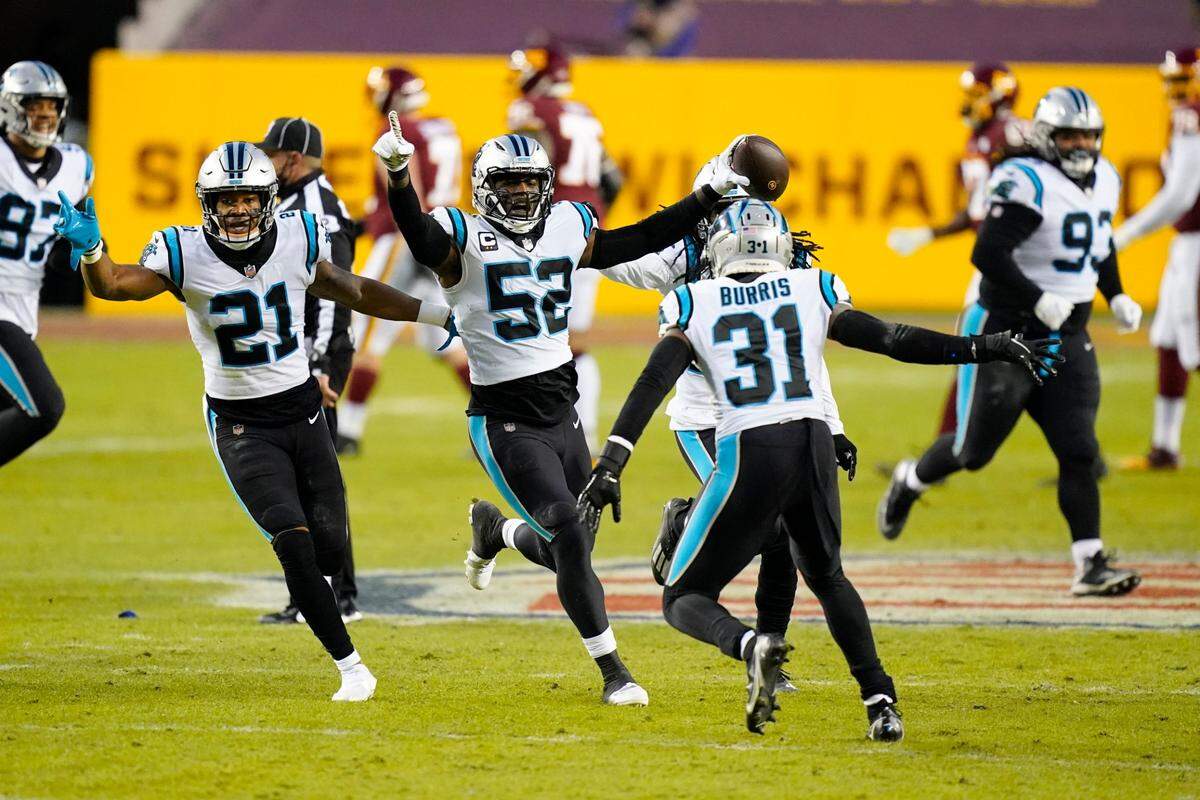Carolina Panthers middle linebacker Tahir Whitehead (52) celebrating his interception with outside linebacker Jeremy Chinn (21), strong safety Juston Burris (31) and others during the first half of an NFL football game against the Washington Football Team, Sunday, Dec. 27, 2020, in Landover, Md. (AP Photo/Carolyn Kaster)