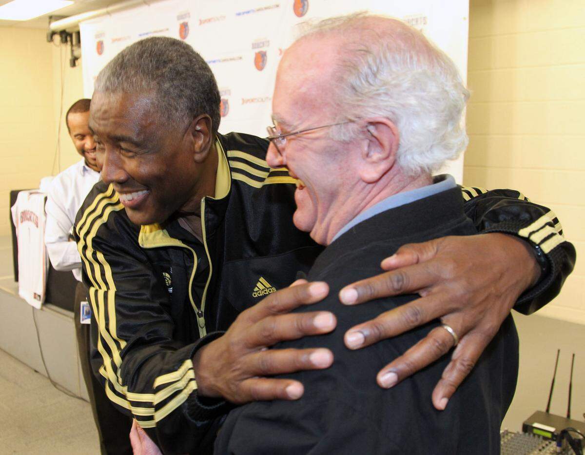 Paul Silas, who once coached the Charlotte NBA franchise, hugs Charlotte Observer sportswriter Leonard Laye after a press conference.