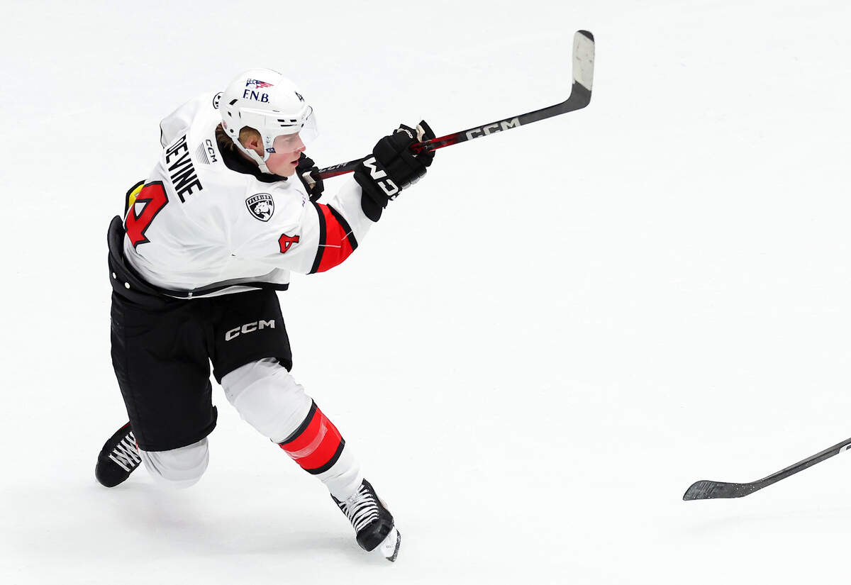 Charlotte Checkers Jack Devine follows through on his shot on goal during second period action against the Iowa Wild on Friday, October 17, 2025 at Bojangles Coliseum in Charlotte, NC. Devine scored on the play.