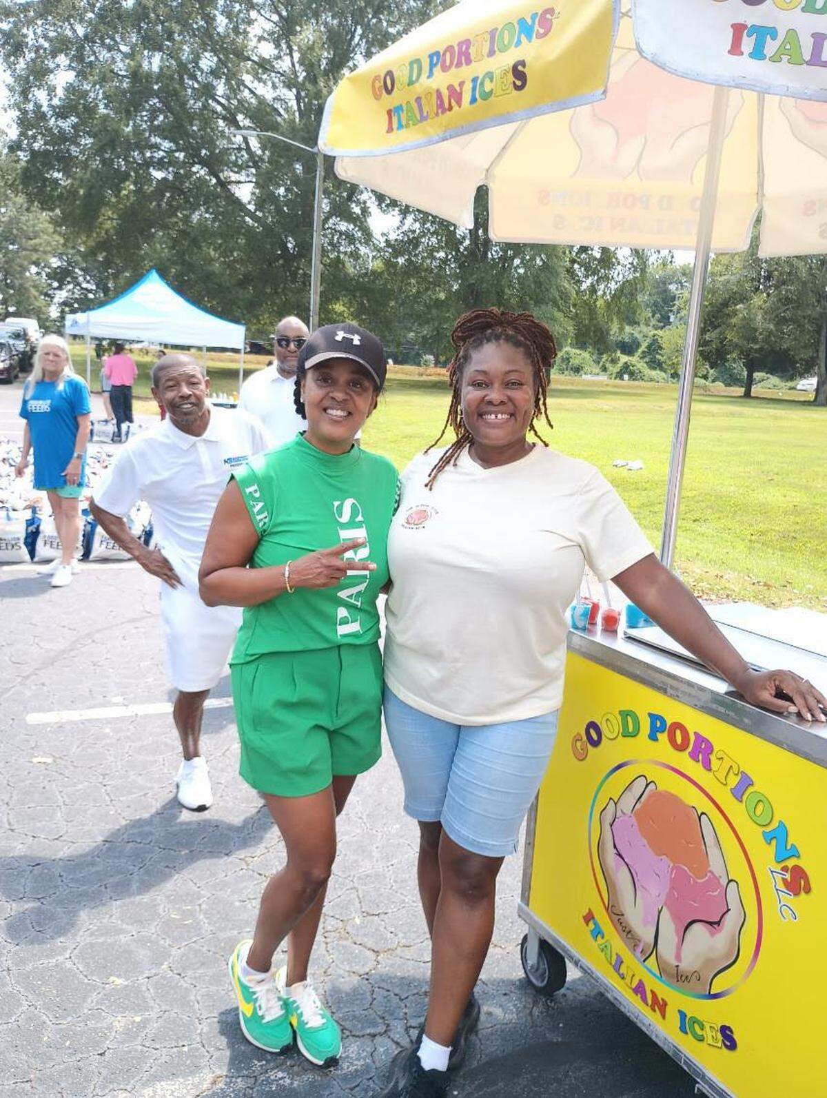 Shaheedah Ross Jackson, owner of Good Portions Italian Ices, poses for a photo with community members.
