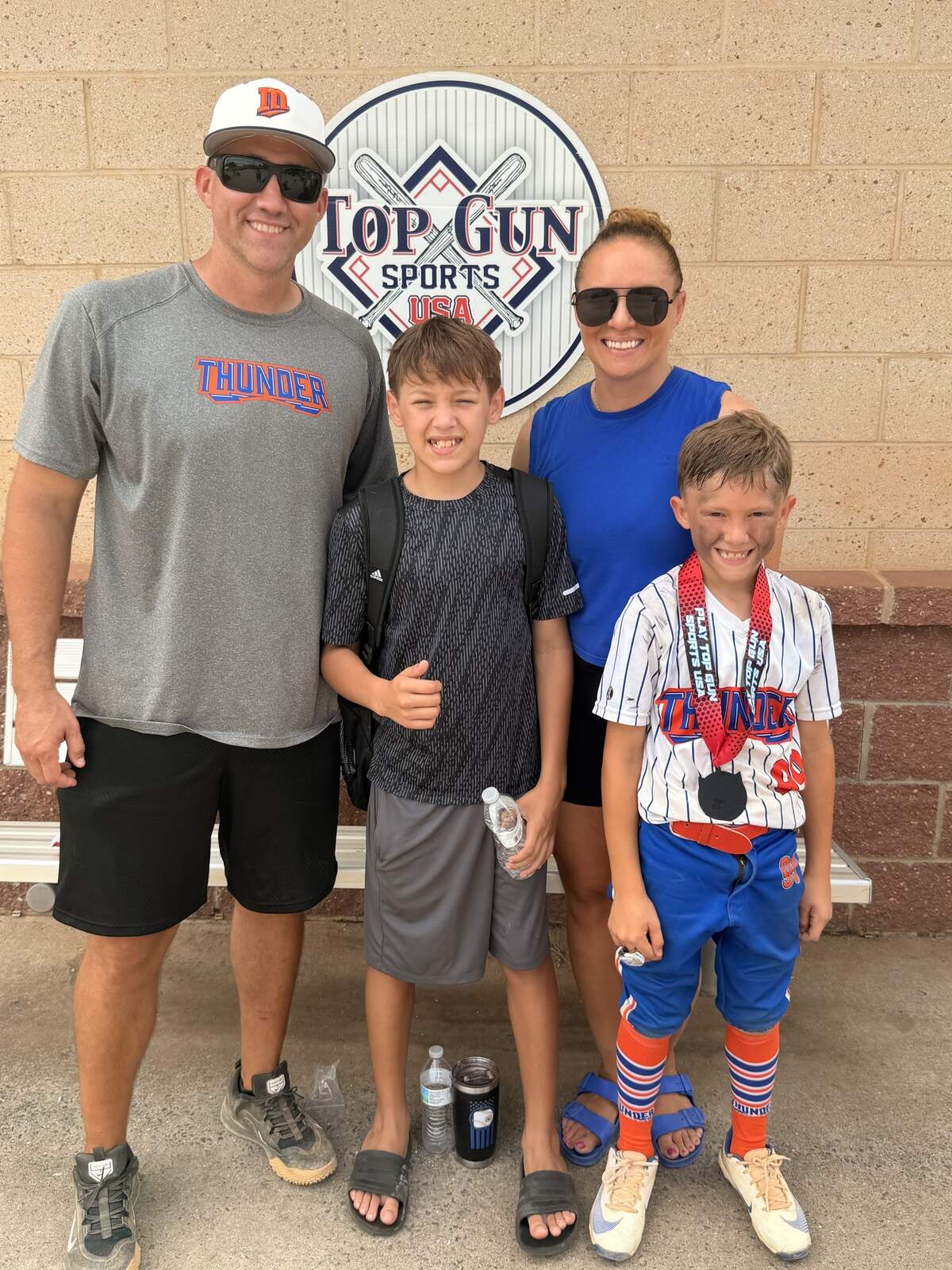 From left: Josh, Kingston, Brittany and Kade Whitlock celebrate after a baseball tournament.