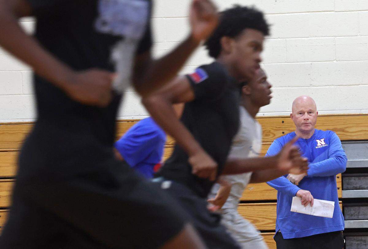 North Meck Vikings head basketball coach Duane Lewis, right, watches players run sprints during practice on Wednesday, November 5, 2025. Lewis has won four NCHSAA championships in his career at the school. The 2025 North Meck boys basketball team is ranked No.1 in the preseason sweet 16.