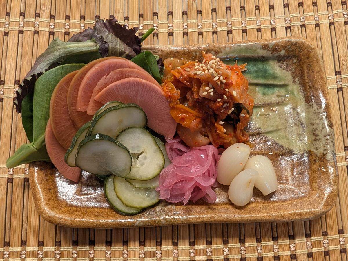 All pickles are made in-house at DŌZO Japanese American Kitchen, including watermelon radish, cucumber, onion and kimchi.