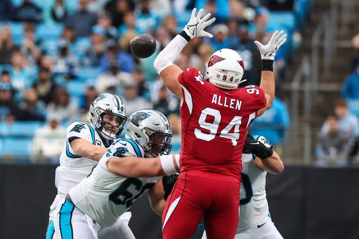 Cardinals defensive lineman Zach Allen, right, stretches out to block a pass by Panthers quarterback Baker Mayfield Sunday. Mayfield leads the NFL in passes batted down at the line.