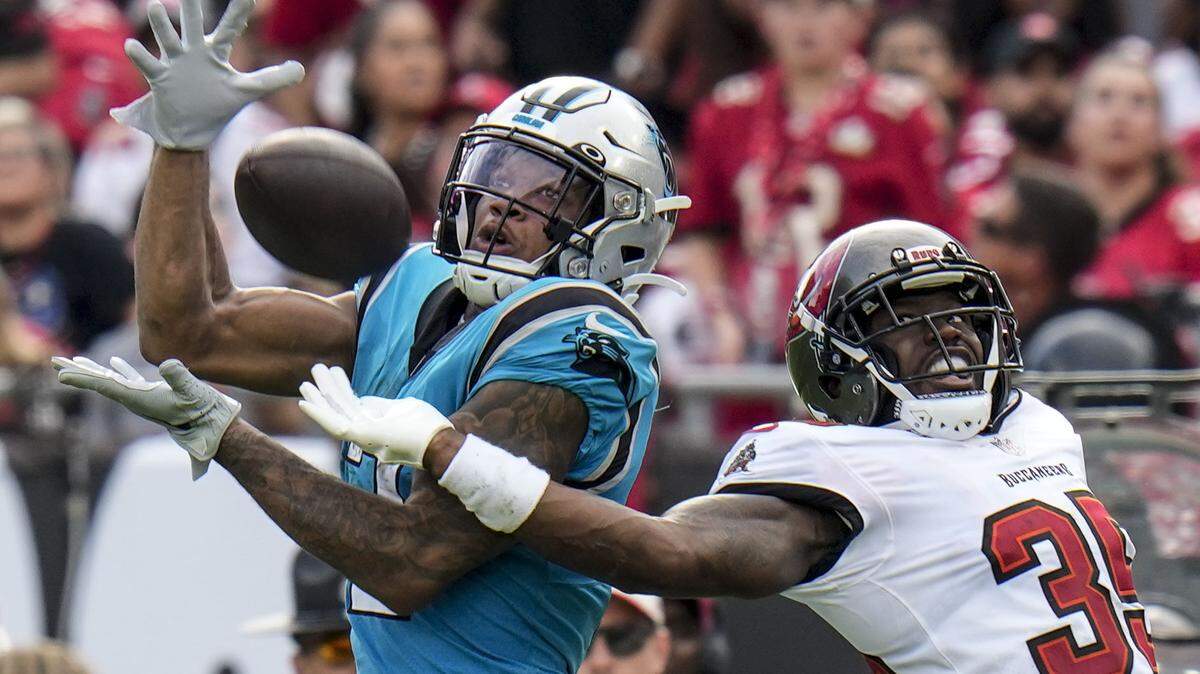 Carolina Panthers wide receiver DJ Moore catches a pass in front of Tampa Bay Buccaneers cornerback Jamel Dean during the second half of an NFL football game between the Carolina Panthers and the Tampa Bay Buccaneers on Sunday, Jan. 1, 2023, in Tampa, Fla. (AP Photo/Chris O’Meara)