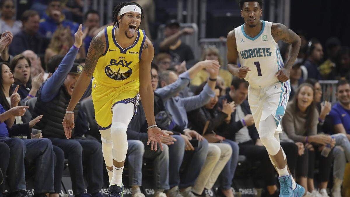 Golden State Warriors guard Damion Lee, left, reacts after scoring next to Charlotte Hornets guard Malik Monk during the first half of an NBA basketball game in San Francisco, Saturday, Nov. 2, 2019. (AP Photo/Jeff Chiu)