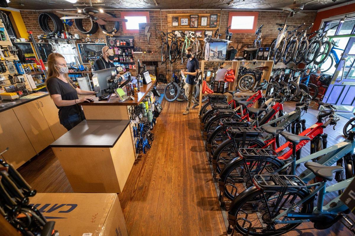 Hailey Modin and Douglas Mitchell assist a client at Charlotte Cycles on Baldwin Avenue, which currently has a healthy supply of bicycles, including motor-assist and recumbent versions.