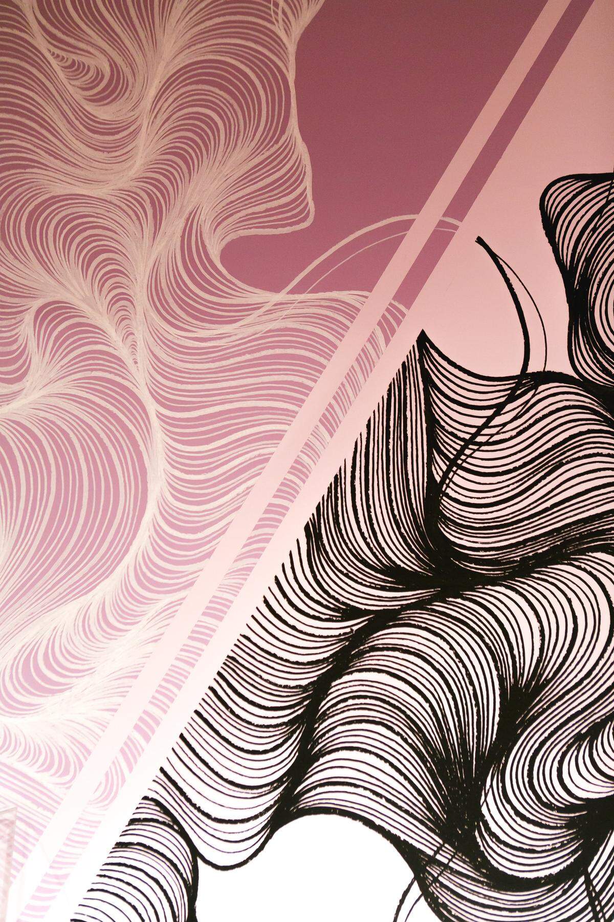 A close-up shot of the artwork done by Owl, a local artist. The Mint Museum asked Owl to create backdrops that would help establish a showroom motif for the “Classic Black” exhibition. She used high flow acrylic markers, also known as graffiti markers, to create the designs.