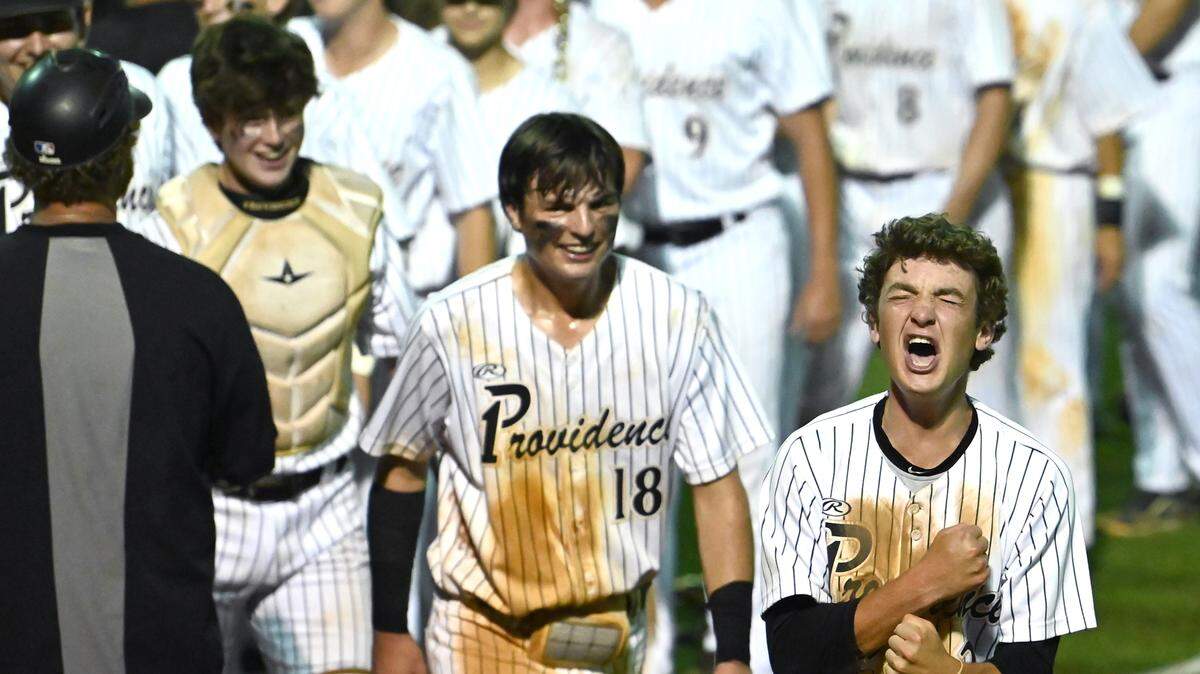 Providence Panthers Jackson Warfield, right, celebrates the team’s 4-3 win over West Forsyth in NC 4A quarterfinal action on Friday, May 20, 2022 at Providence High School.