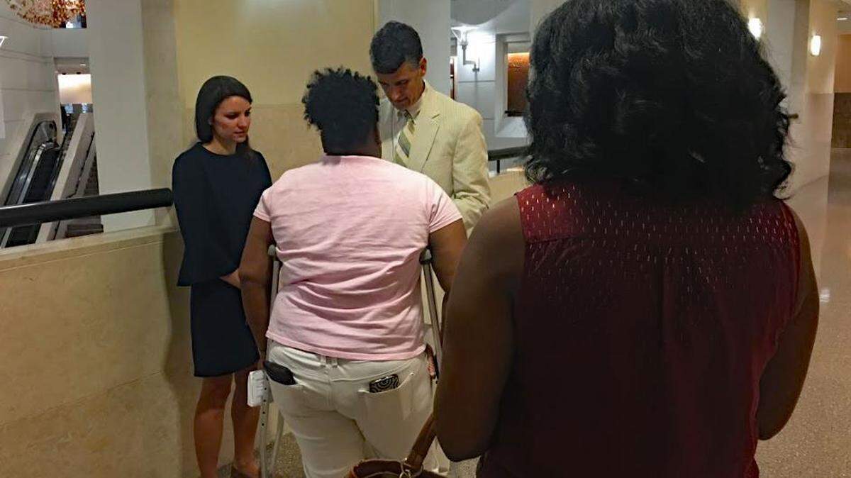 People facing eviction wait to talk to Legal Aid lawyer Tommy Holderness outside courtroom 2350 on Aug. 23. That day he and other Legal Aid lawyers helped five tenants, three of whom had their cases continued due to possible legal issues lawyers found.